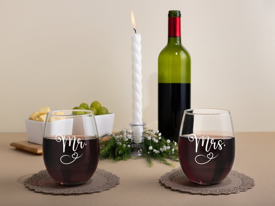 Bride and groom his and hers cups at a wedding reception ready for the