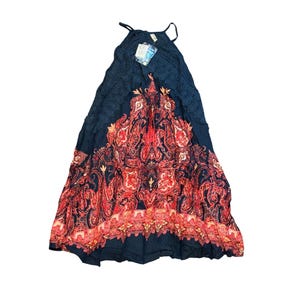 May include: A long, navy blue halter dress with a paisley pattern in red, orange, and gold. The top of the dress features a crocheted design. A tag is attached to the dress.