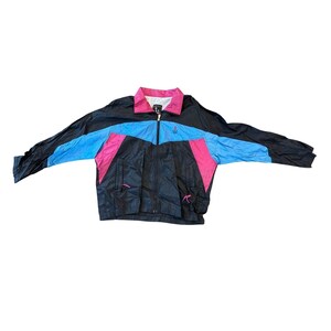 May include: A black, blue, and pink windbreaker jacket with a zipper closure. The jacket has a small logo on the left chest.