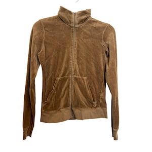 May include: A brown velour zip-up jacket with a high collar and a front pocket. The jacket has a full-length zipper and long sleeves. The fabric has a soft, velvety texture.