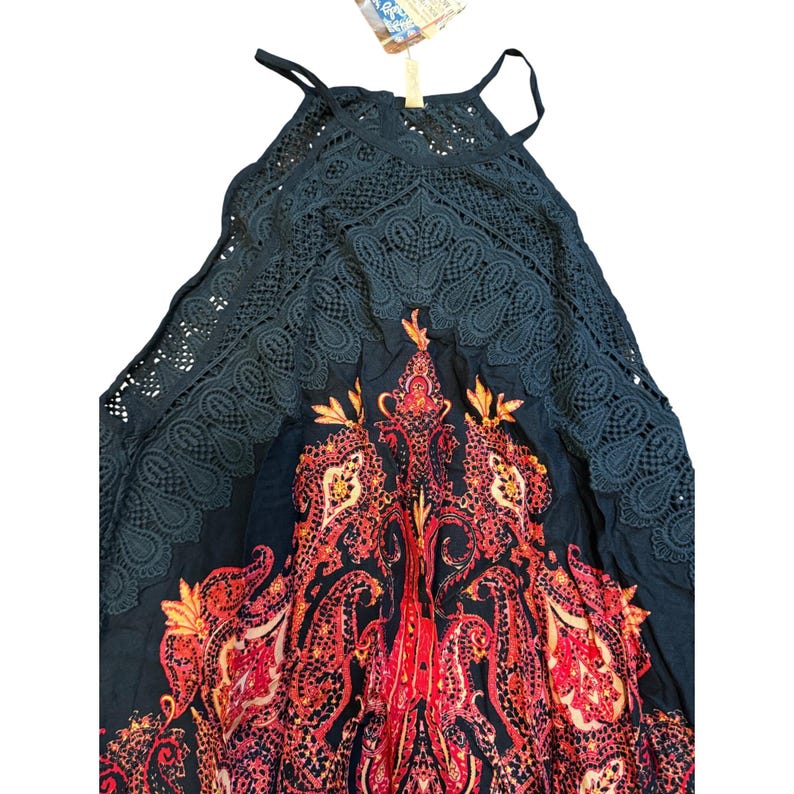 May include: A dark navy blue halter top dress with a paisley pattern in red, orange, and yellow. The top features a lace overlay and spaghetti straps. The dress is a bohemian style.