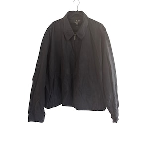 May include: A black zip-up jacket with a collar and long sleeves.