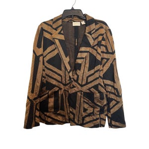 May include: A brown and black patterned blazer with a single-button closure and two front pockets. The blazer is hanging on a black hanger. The pattern consists of geometric shapes.