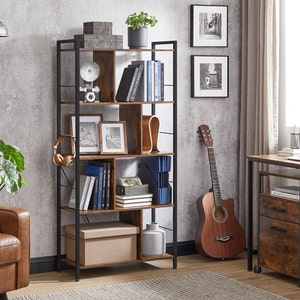 May include: A brown wooden bookshelf with a black metal frame. The bookshelf has six shelves and is filled with books, a plant, a vase, and other decorative items.