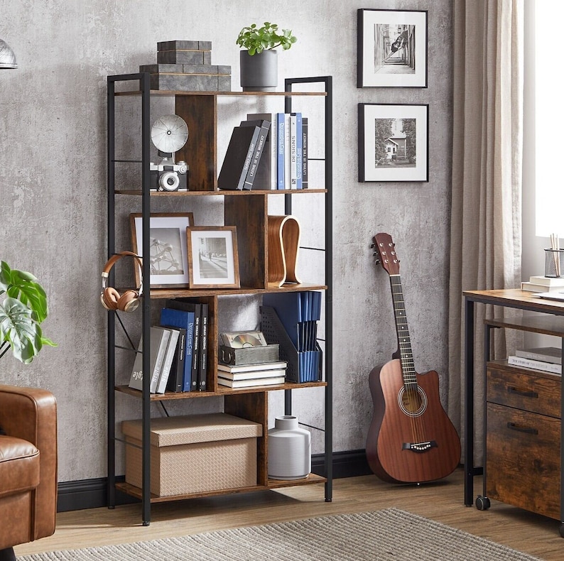 May include: A brown wooden bookshelf with a black metal frame. The bookshelf has six shelves and is filled with books, a plant, a vase, and other decorative items.