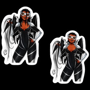 May include: Two stickers featuring a stylized illustration of a character in a black and white bodysuit with silver accents. The character has black wings, a white mask, and long black hair. The character is posed with one hand on their hip.