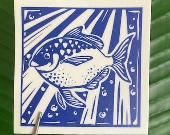 May include: A blue and white illustration of a fish swimming in a blue and white patterned background. The fish has a spotted pattern and is swimming towards the right side of the image.