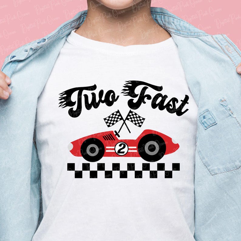 May include: White t-shirt with a red race car graphic and the text "Two Fast." The car has black wheels, the number 2, and checkered flags. A black and white checkered pattern is at the bottom.