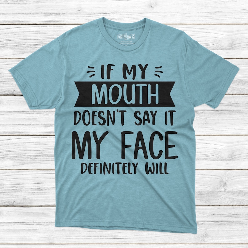 May include: A light blue t-shirt with black text that reads "If my mouth doesn't say it my face definitely will."