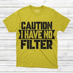 May include: A yellow t-shirt with the text "CAUTION I HAVE NO FILTER" printed in black.