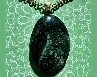 May include: A green and black stone pendant on a gold chain. The stone has a marbled pattern and is oval shaped.