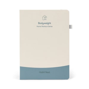 May include: A beige notebook with a blue bottom edge. The notebook has a logo of a house with a person inside and the text "Bodyweight Home Workout Series". The bottom edge of the notebook has the text "Habit Nest".