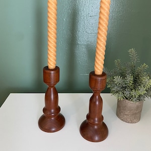 Two vintage brown wood candle holders 7 inches  tall