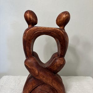 abstract handmade wood carved sculpture of couple embracing 11 1/2 inches tall