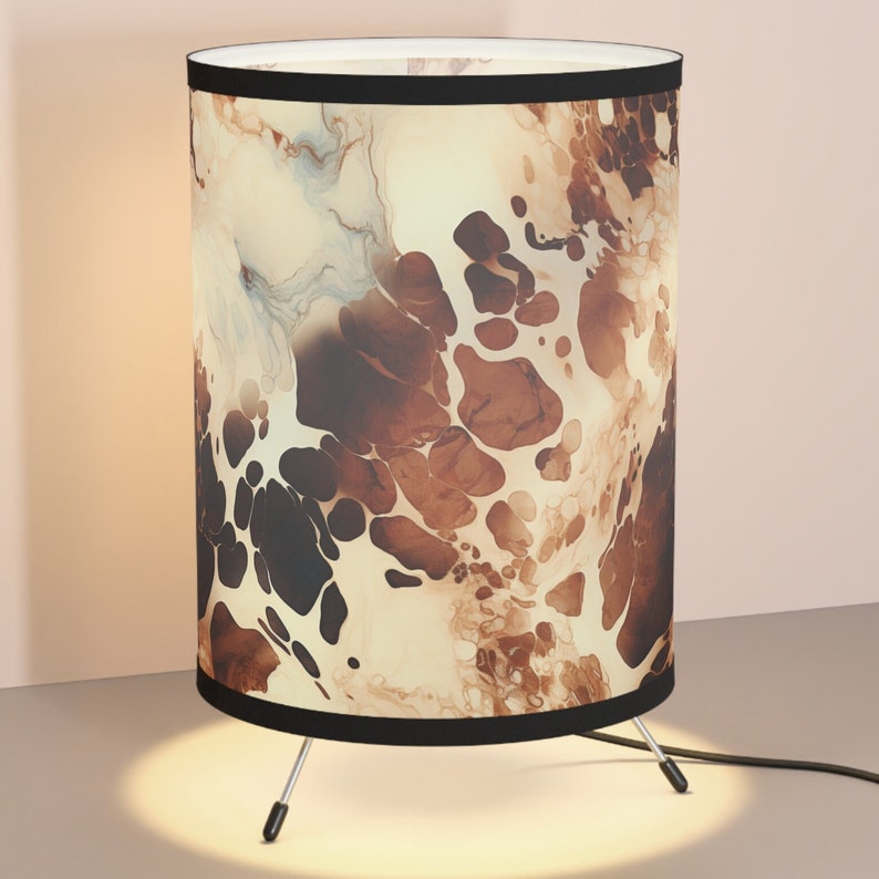 Tripod Desk Lamp with watercolor cowhide pattern in Brown and Cream colors. Lamp has black fabric trim at top and bottom