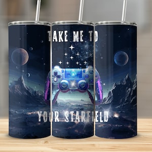 May include: A stainless steel tumbler with a galaxy-themed design featuring a video game controller and the text "Take me to your Starfield".