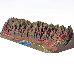 May include: A 3D printed model of a mountain range with a red hiking trail winding through the peaks. The model is made of a brown, green, and blue material and is set against a white background.