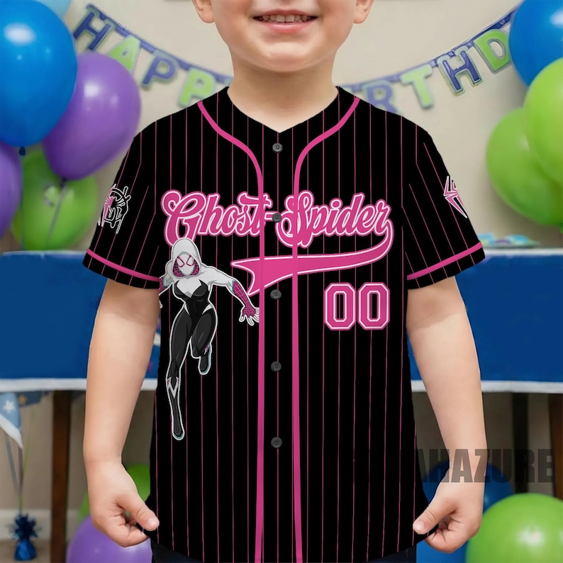 May include: Black baseball jersey with pink pinstripes, featuring the text "Ghost Spider" in pink script, the number "00", and a graphic of a female superhero. The jersey has a button-up front and short sleeves.