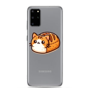 May include: A clear phone case with a gray Samsung phone inside. The case has a cartoon image of a cat shaped like a loaf of bread.
