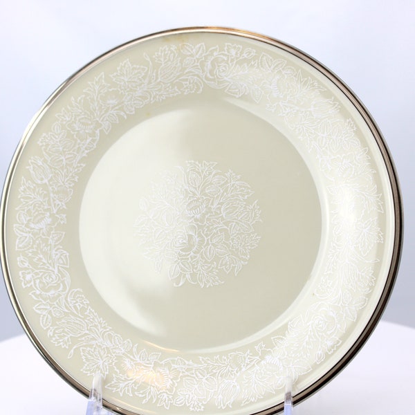 A 8" diameter salad or luncheon plate in the "Moonspun" pattern by Lenox China, cream background, platinum band with white flowers, 1960's.