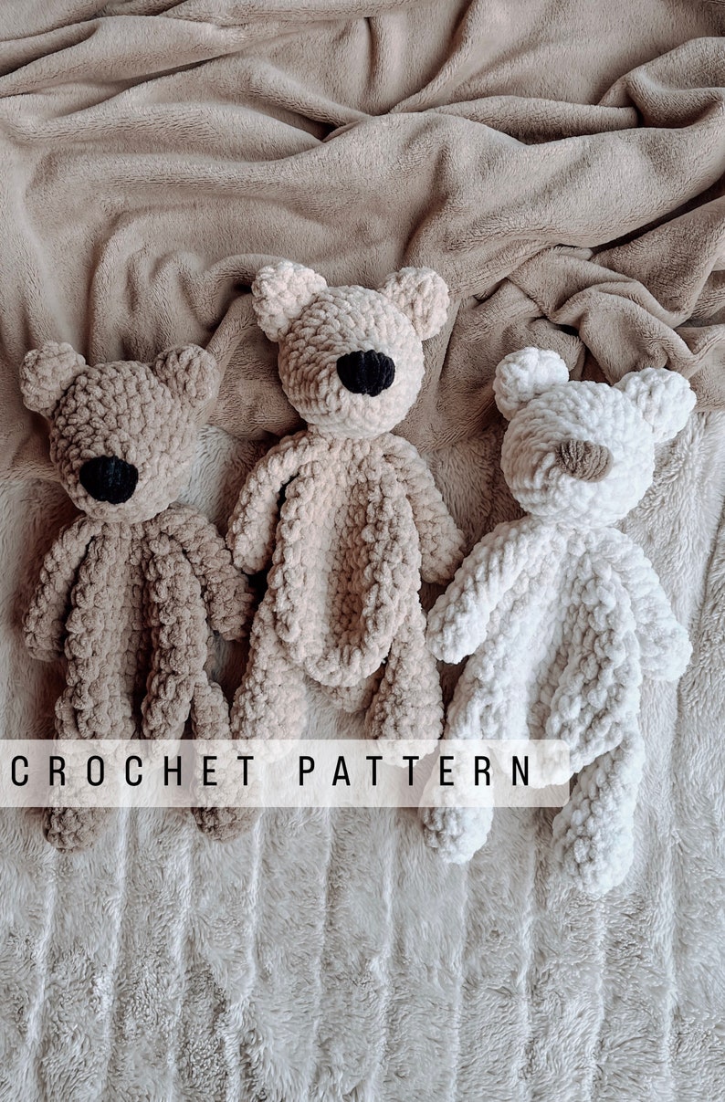 May include: Three crocheted teddy bears in different colours: brown, beige, and white. The bears are lying on a fluffy brown blanket. The text "CROCHET PATTERN" is visible at the bottom of the image.