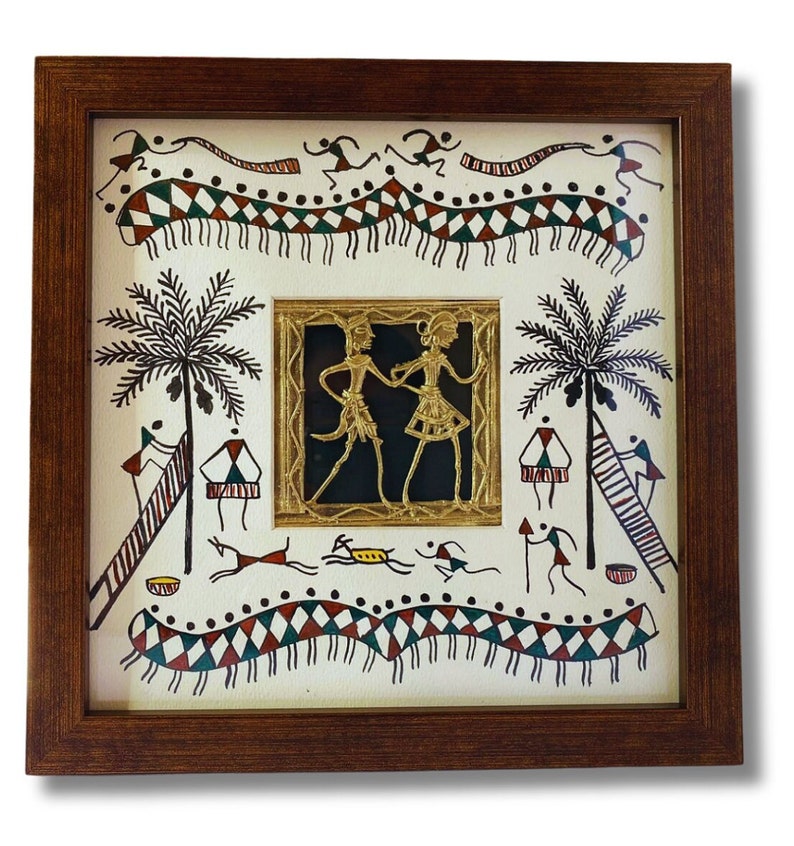 May include: A framed artwork featuring a traditional Indian folk art style. The artwork depicts a scene with two figures dancing in the center, surrounded by palm trees, animals, and geometric patterns. The artwork is framed in a brown wooden frame.