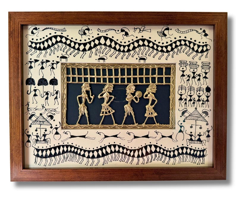 May include: A framed artwork featuring a black and white drawing of people and animals. The artwork is surrounded by a brown wooden frame. A gold metal cutout of four figures is in the centre of the artwork.