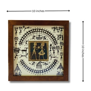 May include: A framed 10-inch square artwork featuring a black and white tribal design with a gold metal cutout of a couple dancing in the center.