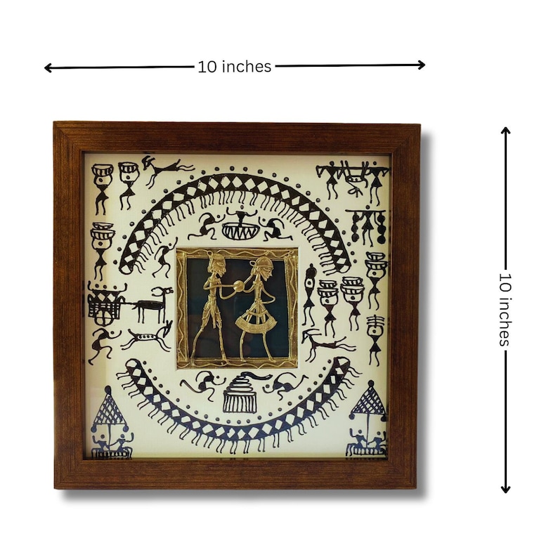 May include: A framed 10-inch square artwork featuring a black and white tribal design with a gold metal cutout of a couple dancing in the center.
