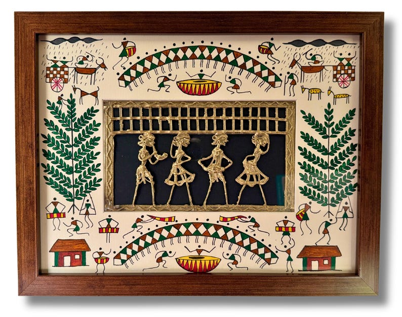 May include: A framed artwork featuring a traditional Indian folk art style. The artwork depicts a central panel with four figures in a dancing pose, crafted from brass and set against a dark blue background. The surrounding frame is decorated with a white background and colourful illustrations of people, animals, and plants.
