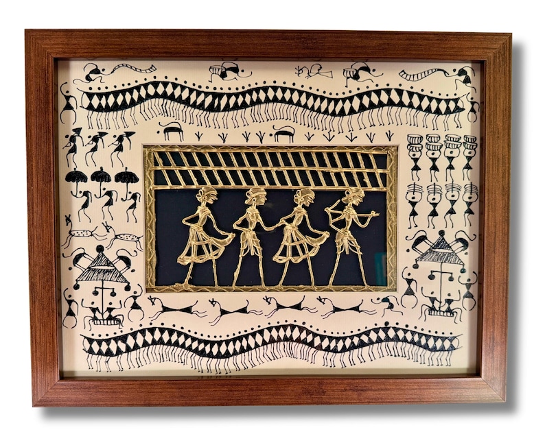 May include: A framed artwork depicting a traditional Indian folk art style with black and white figures and a central gold-coloured metal panel featuring four figures dancing under a striped canopy.
