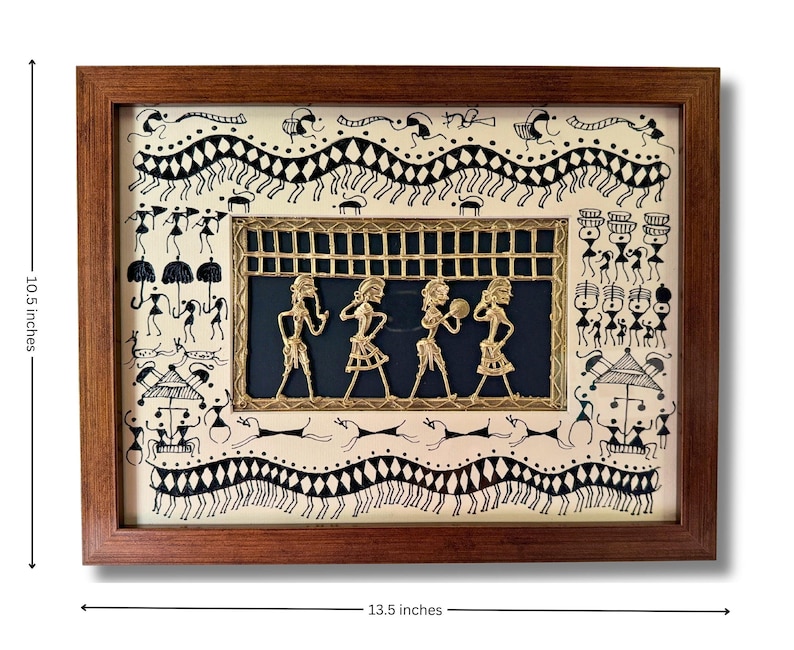 May include: A framed artwork depicting a traditional Indian folk art style with black and white line drawings of people and animals. The artwork features a central panel with four figures made of gold metal, set against a dark blue background. The frame is made of dark wood and measures 13.5 inches by 10.5 inches.