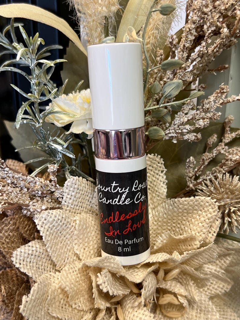 Puede incluir: Botella blanca con una etiqueta en blanco y negro que dice "Country Road Candle Co. Endlessly In Love Eau De Parfum 8 ml".