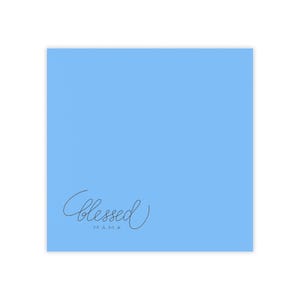 May include: A pale blue square featuring the word "Blessed" in a cursive script, with "MAMA" beneath in a smaller, sans-serif font. The text is a dark grey colour.