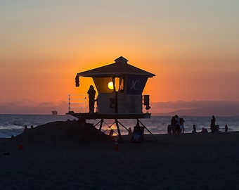 Huntington Beach Pier lifeguard at sunset