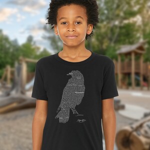 May include: Black t-shirt with a silhouette of a raven made from the text of Edgar Allan Poe's poem "The Raven".