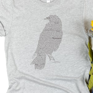May include: Gray t-shirt with a black silhouette of a raven made from the text of Edgar Allan Poe's poem "The Raven". The text includes the famous line "Nevermore".