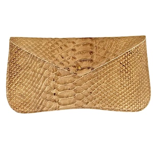 May include: A gold-toned snakeskin clutch bag with a flap closure and a gold button.
