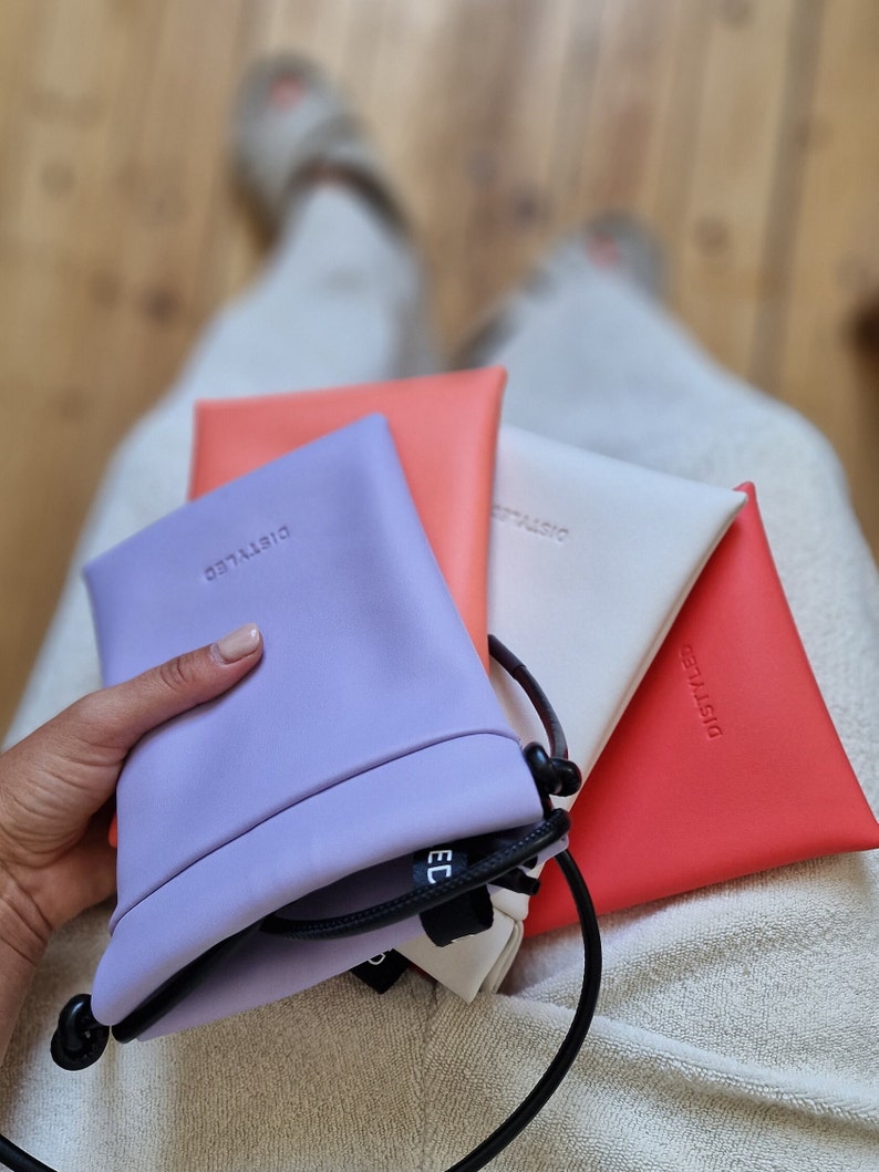 Purple, pink (coral), white, and red shoulder pouches