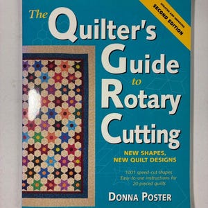May include: The book titled The Quilter's Guide to Rotary Cutting, Second Edition by Donna Poster, features a bright blue cover with a colourful star-patterned quilt image, yellow corner banner, and white text detailing 1001 speed-cut shapes.