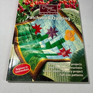 May include: A softcover book titled Company's Coming Crafts Patchwork Quilting. The cover features a quilted blanket with star patterns in red, purple, and orange on a green and blue background. Text includes 52 Easy-to-follow projects.