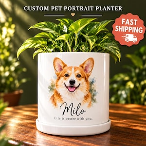 May include: A white ceramic cylindrical planter featuring a watercolor illustration of a tan and white Corgi dog. The text Milo and Life is better with you. is printed below the dog. The planter sits on a matching white saucer.