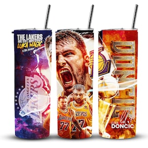 May include: Three stainless steel tumblers with lids and straws. The tumblers feature different designs with basketball players and the text "THE LAKERS ARE STILL UNBEATABLE LUKA MAGIC IS THE REASON" and "LUKA DONCIC".