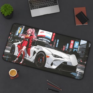 May include: A white sports car with red accents and a pink-haired anime character standing next to it. The car is on a city street with neon signs and buildings in the background. The mousepad is black with a glossy finish.