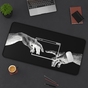 May include: Black rectangular desk mat featuring a white dot illustration of two hands reaching towards each other, with a computer window graphic. The text "PROJECT.EXE" is visible. A white mouse is on the mat.