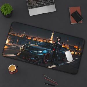 May include: A black rectangular mouse pad featuring a dark blue sports car with red accents, a woman in a black outfit, and a city skyline at night. A white mouse is on the pad.