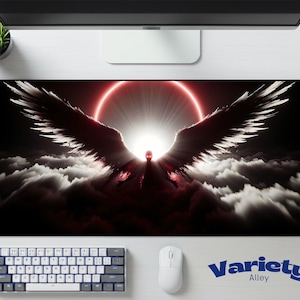May include: A black and red mousepad featuring a dramatic angel design with outstretched wings against a bright light and cloud background. The mousepad has the text "Variety Alley" in blue.