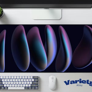 May include: A rectangular desk mat with a dark blue background and abstract, elongated shapes in shades of purple, teal, and pink. The mat features the text "Variety Alley" in blue. A white keyboard and mouse are visible.