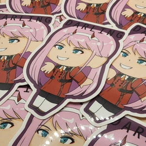 May include: A collection of stickers featuring a cartoon character with pink hair, blue eyes, and red horns. The character is wearing a red uniform. The word "DARLING" is printed on the stickers.