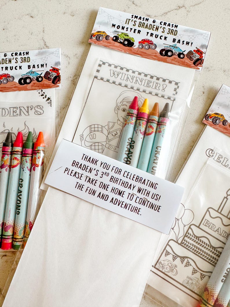 May include: A white paper bag with a coloring page featuring a monster truck and a birthday cake. The bag includes a thank you note that says "Thank you for celebrating Braden's 3rd birthday with us! Please take one home to continue the fun and adventure." The bag also includes a set of crayons.